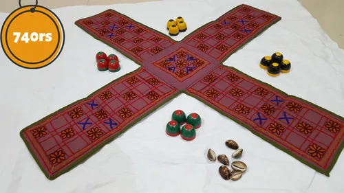 Pachisi board (cross-shaped) with cowrie shells